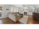 Cozy living room featuring a fireplace, built-in shelves, and large windows with plantation shutters at 109 Skywater Ln, Holly Springs, NC 27540