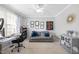 Bright home office with a comfortable couch, modern decor, and lots of natural light at 109 Skywater Ln, Holly Springs, NC 27540