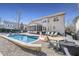 Backyard with a sparkling pool, lounge chairs, screened in porch and outdoor seating at 109 Skywater Ln, Holly Springs, NC 27540