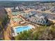 Aerial view of a neighborhood community with a pool, clubhouse, tennis courts, and ample parking at 1100 Gaston Manor Dr, Durham, NC 27703
