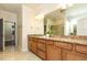 Bathroom featuring double vanities with granite countertops and tiled floors at 1100 Gaston Manor Dr, Durham, NC 27703