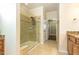 Bathroom with a glass enclosed tiled shower and access to the walk-in closet at 1100 Gaston Manor Dr, Durham, NC 27703