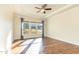 A light-filled bedroom featuring hardwood floors, a tray ceiling, and large windows at 1100 Gaston Manor Dr, Durham, NC 27703