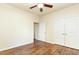 Bedroom with hardwood floors, a ceiling fan, and a double door closet at 1100 Gaston Manor Dr, Durham, NC 27703