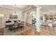 Open-concept dining room and living room featuring hardwood floors and neutral paint at 1100 Gaston Manor Dr, Durham, NC 27703