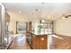 Open concept kitchen with island, stainless steel appliances, and hardwood flooring at 1100 Gaston Manor Dr, Durham, NC 27703