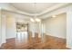 Spacious living room with hardwood flooring and open layout, with adjacent dining area at 1100 Gaston Manor Dr, Durham, NC 27703
