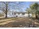 The backyard of this home has mature trees, lush greenery, and a well-maintained lawn at 11254 Hwy Nc 50, Benson, NC 27504