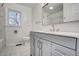 Nicely remodeled bathroom with gray cabinets, modern fixtures, and a walk-in shower at 11254 Hwy Nc 50, Benson, NC 27504