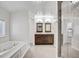 Bathroom featuring a separate shower and soaking tub, and a wood vanity with dual sinks at 11254 Hwy Nc 50, Benson, NC 27504