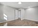 Bedroom with neutral paint and hardwood floors leading to a view into the bathroom at 11254 Hwy Nc 50, Benson, NC 27504