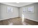 Bright bedroom featuring hardwood floors and two windows providing natural light at 11254 Hwy Nc 50, Benson, NC 27504