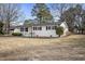 Charming white-brick ranch home with black shutters and a welcoming front porch, nestled in a wooded yard at 11254 Hwy Nc 50, Benson, NC 27504