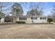 Inviting ranch home featuring a covered carport, freshly painted white brick, and black shutters, set on a spacious lot at 11254 Hwy Nc 50, Benson, NC 27504
