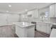 Spacious kitchen boasting white cabinets, an island with a countertop, and an adjoining dining area at 11254 Hwy Nc 50, Benson, NC 27504
