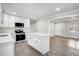 Eat-in kitchen featuring white cabinets, stainless steel appliances and an island with quartz countertop at 11254 Hwy Nc 50, Benson, NC 27504