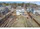 An aerial view of the fenced backyard with a patio, fire pit, playset, and spacious lawn at 115 Lockamy Ln, Youngsville, NC 27596