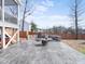 Relax on the stamped concrete patio with a stone fire pit and lounge chairs in the backyard at 115 Lockamy Ln, Youngsville, NC 27596