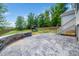 Spacious backyard with patio, playground, and a wooden fence at 115 Lockamy Ln, Youngsville, NC 27596