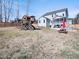Expansive backyard with playset, patio with fire pit, perfect for outdoor enjoyment and entertaining at 115 Lockamy Ln, Youngsville, NC 27596