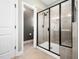 Modern bathroom featuring a tiled shower with sleek, black-framed glass door at 115 Lockamy Ln, Youngsville, NC 27596