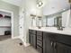 Modern bathroom features dual sinks, dark cabinetry, and elegant fixtures at 115 Lockamy Ln, Youngsville, NC 27596