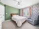 Bedroom with a floral accent wall, a cozy chair, and a window letting in natural light at 115 Lockamy Ln, Youngsville, NC 27596