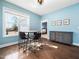 Inviting dining area with a wood table, modern light fixture, and a view to the outside at 115 Lockamy Ln, Youngsville, NC 27596