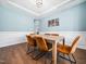 Elegant dining room boasting hardwood floors, wainscoting, and modern light fixtures at 115 Lockamy Ln, Youngsville, NC 27596