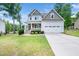 Two-story home with attached garage and large front yard offering curb appeal at 115 Lockamy Ln, Youngsville, NC 27596