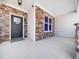 View of a front porch with stone accents and a covered entrance at 115 Lockamy Ln, Youngsville, NC 27596