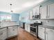 Bright kitchen with white cabinets, stainless steel appliances, and granite countertops at 115 Lockamy Ln, Youngsville, NC 27596