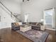 Spacious living room with a neutral color palette, large sectional sofa, and a decorative rug at 115 Lockamy Ln, Youngsville, NC 27596