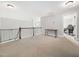 Upstairs loft area with neutral carpet and a small desk area at 115 Lockamy Ln, Youngsville, NC 27596