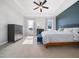Main bedroom boasts large windows that provide natural light, a blue accent wall, and tray ceilings for added height at 115 Lockamy Ln, Youngsville, NC 27596