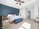 Comfortable main bedroom with a tray ceiling, accent wall, and ensuite bathroom at 115 Lockamy Ln, Youngsville, NC 27596