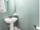 Charming powder room features a pedestal sink and soft green walls at 115 Lockamy Ln, Youngsville, NC 27596