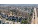 A high aerial of a neighborhood with mature trees surrounding well-kept homes near a main road at 12345 Beestone Ln, Raleigh, NC 27614
