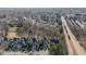 A high aerial of a neighborhood with mature trees surrounding well-kept homes near a main road at 12345 Beestone Ln, Raleigh, NC 27614