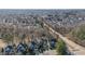 A high aerial of a neighborhood with mature trees surrounding well-kept homes near a main road at 12345 Beestone Ln, Raleigh, NC 27614