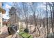 Wooded backyard view of a well-maintained wooded area and a distant golf course, visible from an upper porch at 12345 Beestone Ln, Raleigh, NC 27614