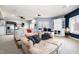 Finished basement with a large sectional sofa, projector, wet bar, white cabinetry, and a popcorn machine at 12345 Beestone Ln, Raleigh, NC 27614