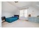 Bright bedroom with a sloped ceiling, light-colored walls, and a window offering natural light at 12345 Beestone Ln, Raleigh, NC 27614