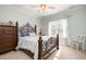 Charming bedroom with a decorative wrought iron bed frame and plenty of natural light at 12345 Beestone Ln, Raleigh, NC 27614