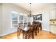 Bright dining room with large windows, chandelier, and hardwood floors, perfect for Gathering gatherings at 12345 Beestone Ln, Raleigh, NC 27614