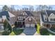 Charming brick and siding home with a two-car garage and well-manicured lawn at 12345 Beestone Ln, Raleigh, NC 27614