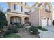 Inviting front entrance showcasing brickwork, arched entryway, and a landscaped garden at 12345 Beestone Ln, Raleigh, NC 27614