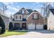 Traditional home featuring a brick facade, shingle accents, and a two-car garage at 12345 Beestone Ln, Raleigh, NC 27614