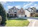 Charming brick and shingle home with a well-manicured lawn and a two-car garage at 12345 Beestone Ln, Raleigh, NC 27614