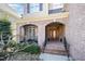 Welcoming front porch with brick columns, a decorative front door, and a cozy seating area at 12345 Beestone Ln, Raleigh, NC 27614